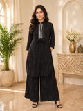 Kanti black kurta with silver disc-placket and tassels, paired with wide-leg black palazzo pants.