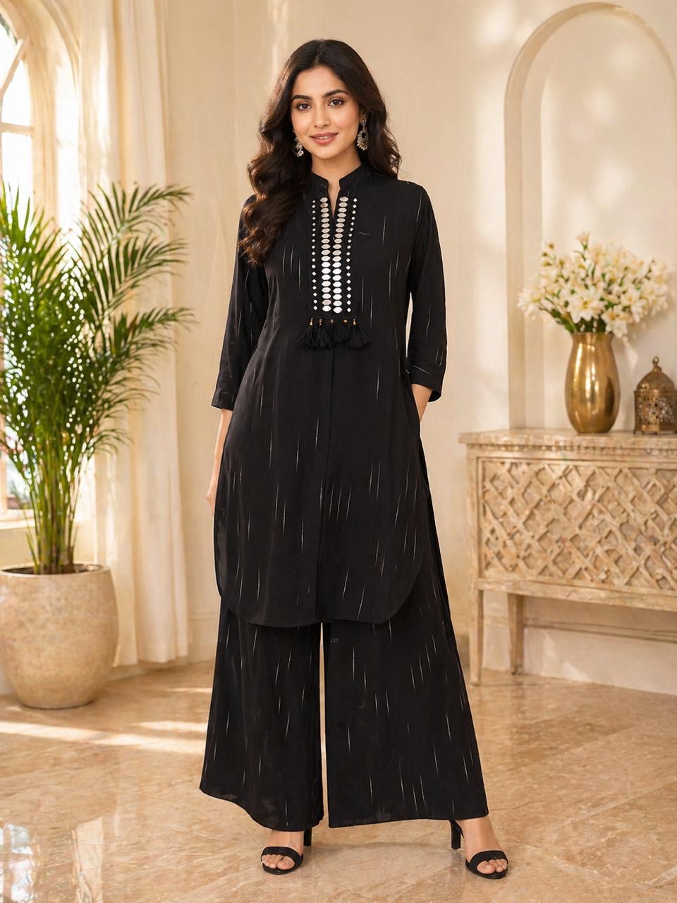 Kanti black kurta with silver disc-placket and tassels, paired with wide-leg black palazzo pants.